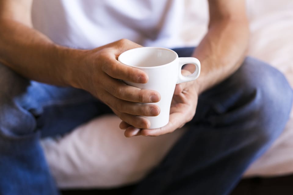 Man Holding Cup